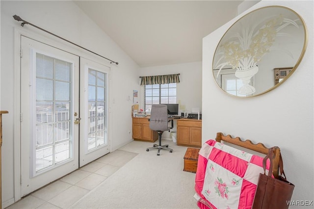 office featuring vaulted ceiling, french doors, and light carpet