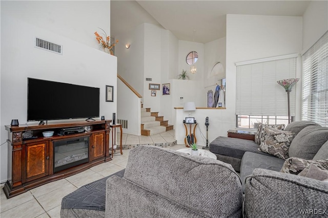 living area with light tile patterned floors, plenty of natural light, and visible vents