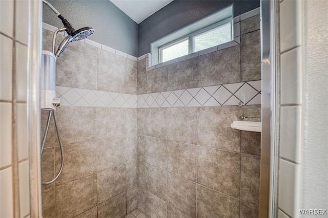 bathroom with a tile shower