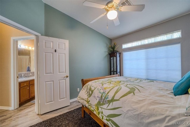 bedroom featuring light wood-type flooring, lofted ceiling, baseboards, and ceiling fan