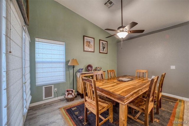 dining area featuring visible vents, ceiling fan, baseboards, and wood finished floors