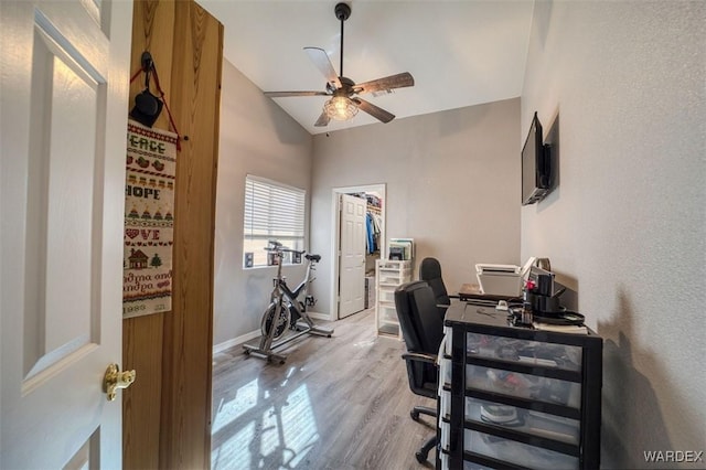 home office featuring vaulted ceiling, baseboards, ceiling fan, and wood finished floors