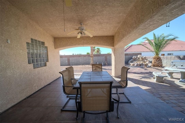 view of patio / terrace featuring outdoor dining area, a fenced backyard, and ceiling fan