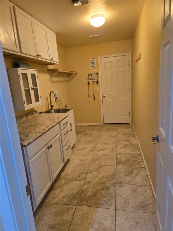 3836 Heather Ave, Kingman, AZ 86401 - laundry area with cabinet space, washer hookup, baseboards, hookup for an electric dryer, and light tile patterned floors