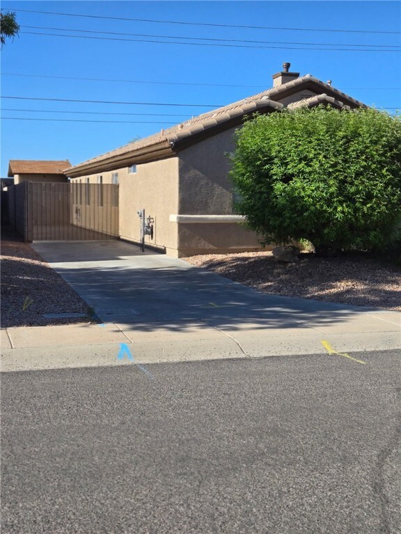 3836 Heather Ave, Kingman, AZ 86401 - view of side of property featuring stucco siding and a tile roof