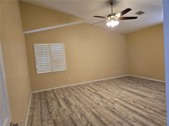 3836 Heather Ave, Kingman, AZ 86401 - spare room with wood finished floors, ceiling fan, lofted ceiling, and baseboards