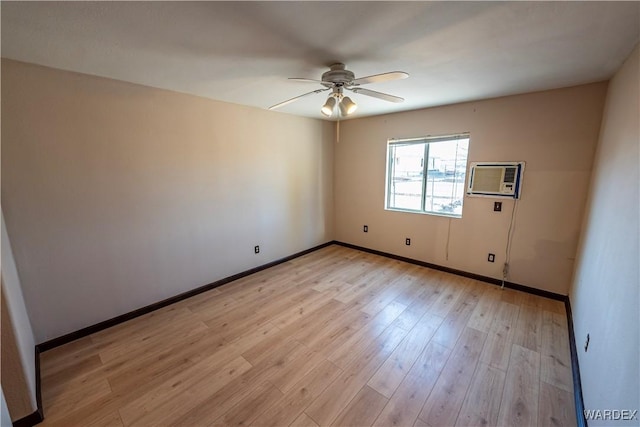 empty room featuring light wood finished floors, baseboards, a ceiling fan, and a wall mounted AC