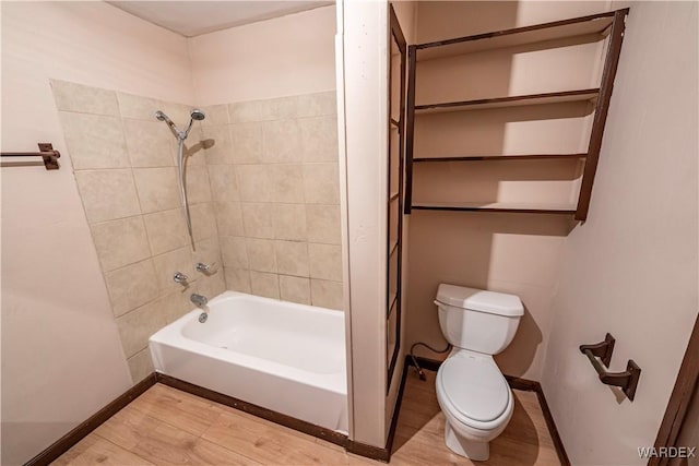 full bath with toilet, shower / bath combination, baseboards, and wood finished floors