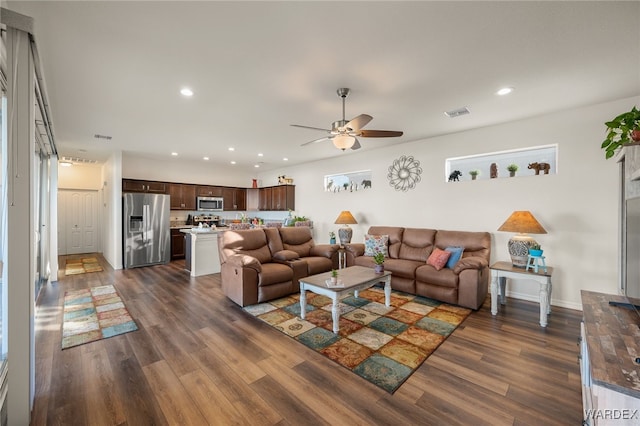 living room featuring dark wood-style floors, visible vents, a ceiling fan, and recessed lighting