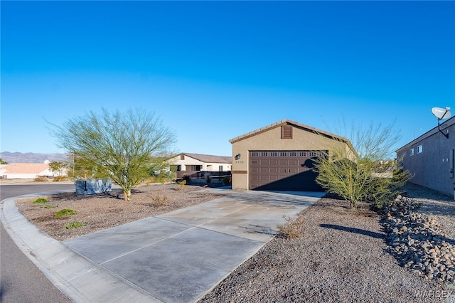 view of side of home with a garage and stucco siding