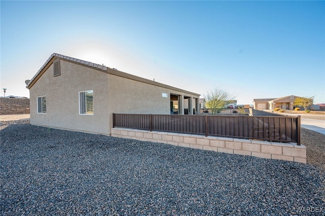 view of side of property featuring stucco siding