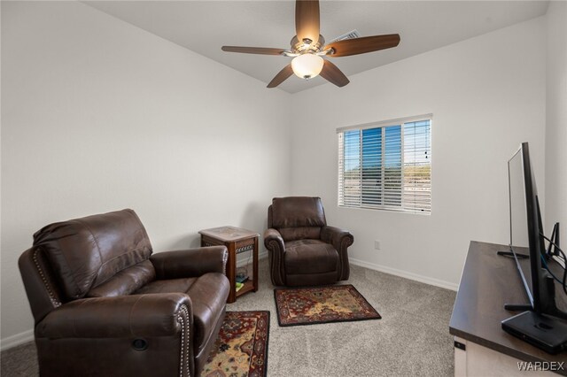 living area with carpet, a ceiling fan, and baseboards