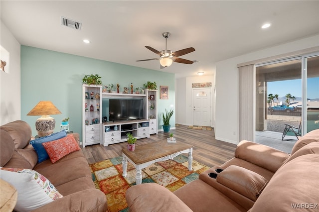 living room with baseboards, visible vents, a ceiling fan, wood finished floors, and recessed lighting