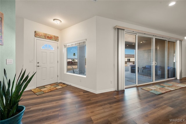 foyer entrance featuring dark wood-style floors and baseboards