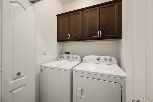 laundry area with cabinet space and washer and clothes dryer