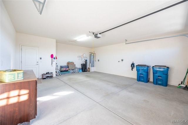 garage with a garage door opener and electric water heater