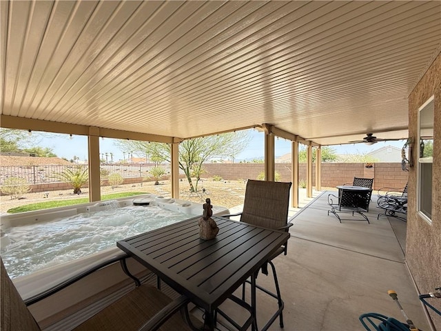 2600 Slide Mountain Loop, Bullhead City, AZ 86442 - fenced backyard featuring a patio area, a hot tub, outdoor dining area, and ceiling fan