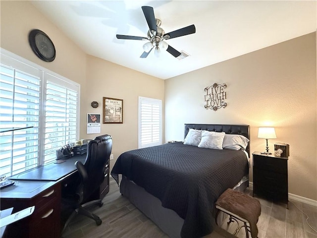 2600 Slide Mountain Loop, Bullhead City, AZ 86442 - bedroom featuring multiple windows, wood finished floors, a desk, and ceiling fan