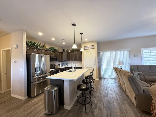 2600 Slide Mountain Loop, Bullhead City, AZ 86442 - kitchen featuring appliances with stainless steel finishes, open floor plan, dark brown cabinets, dark wood-style flooring, and recessed lighting