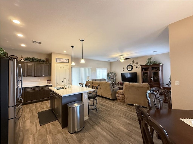 2600 Slide Mountain Loop, Bullhead City, AZ 86442 - kitchen with stainless steel fridge, ceiling fan, dark brown cabinets, light countertops, and open floor plan