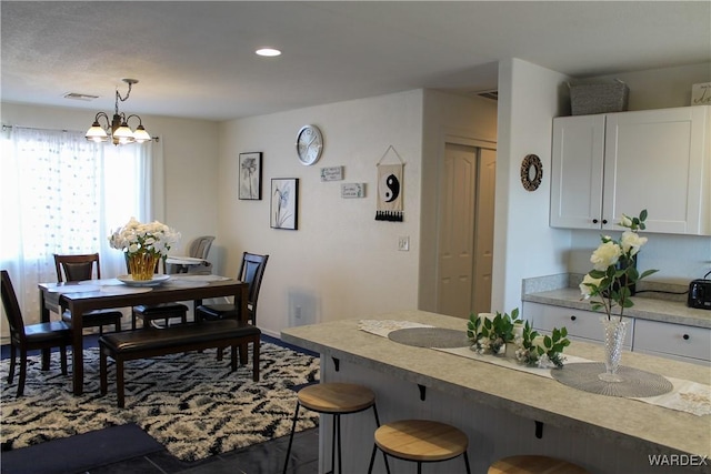 dining space featuring visible vents, dark tile patterned flooring, and recessed lighting