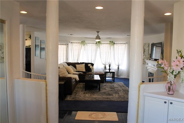 living room featuring recessed lighting, a ceiling fan, and dark tile patterned flooring