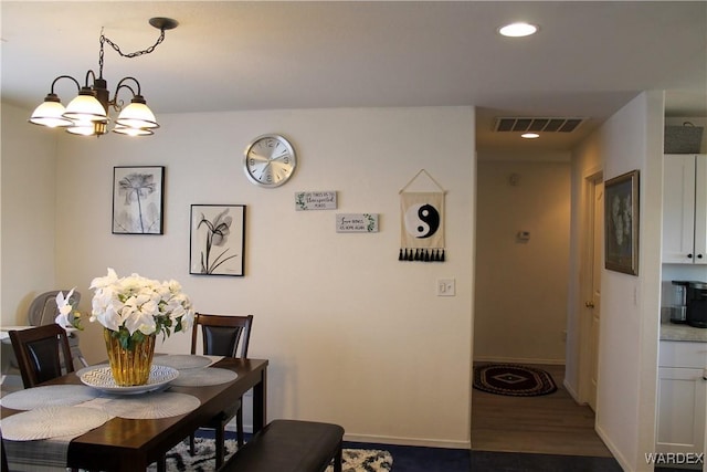 dining room with baseboards, visible vents, dark wood-style floors, a chandelier, and recessed lighting