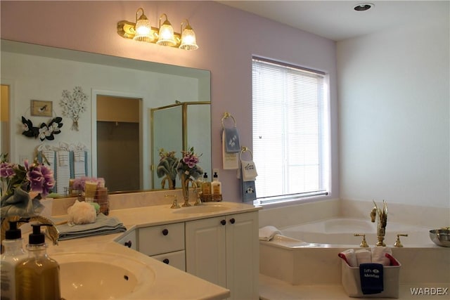 full bathroom with a garden tub, vanity, and a shower stall