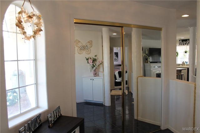 interior space with dark tile patterned flooring, plenty of natural light, and recessed lighting