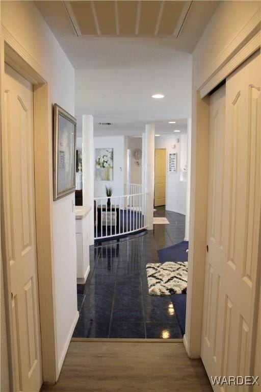 hall with dark wood finished floors and visible vents