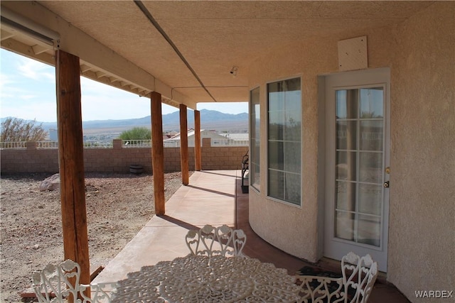 view of patio with a fenced backyard and a mountain view