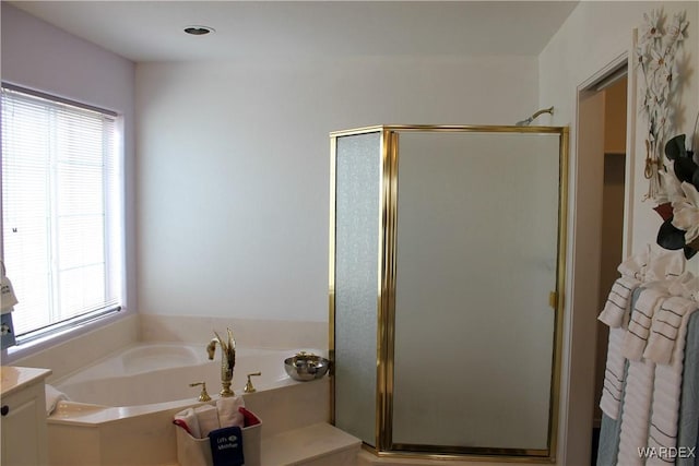 full bath with a shower stall, a bath, and vanity