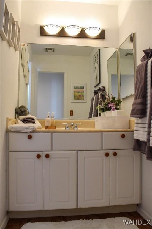 bathroom featuring visible vents and vanity