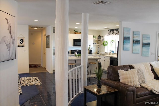 living area featuring recessed lighting, visible vents, and dark tile patterned floors