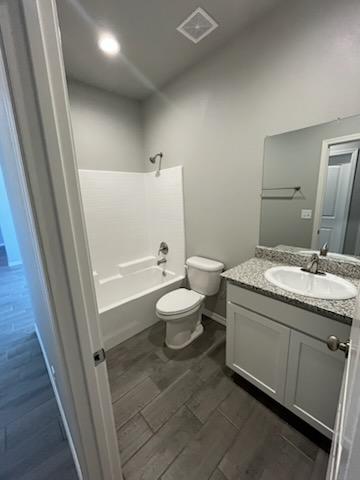 3515 E Lum Ave, Kingman, AZ 86409 - bathroom with toilet, vanity, bathtub / shower combination, and wood tiled floors