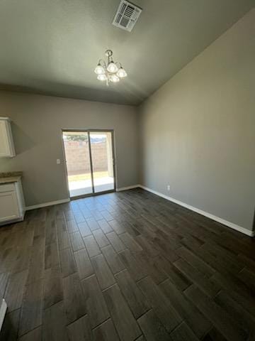 3515 E Lum Ave, Kingman, AZ 86409 - empty room with a chandelier, dark wood finished floors, baseboards, and vaulted ceiling
