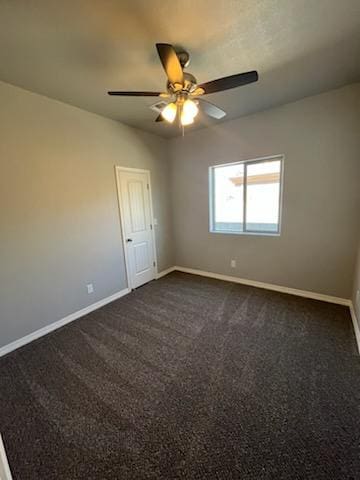 3515 E Lum Ave, Kingman, AZ 86409 - spare room featuring baseboards, a ceiling fan, and dark carpet