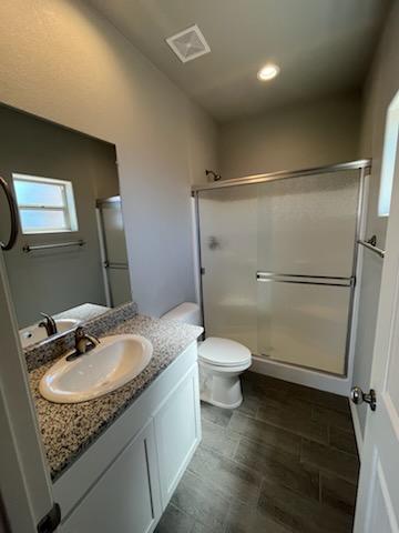 3515 E Lum Ave, Kingman, AZ 86409 - bathroom featuring a stall shower, vanity, toilet, and recessed lighting