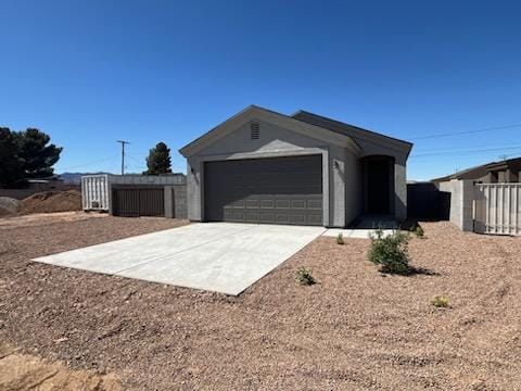 3515 E Lum Ave, Kingman, AZ 86409 - view of front of house featuring driveway, an attached garage, fence, and stucco siding