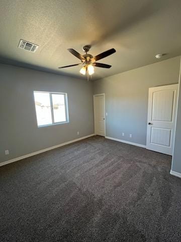 3515 E Lum Ave, Kingman, AZ 86409 - unfurnished room with baseboards, dark colored carpet, and a ceiling fan