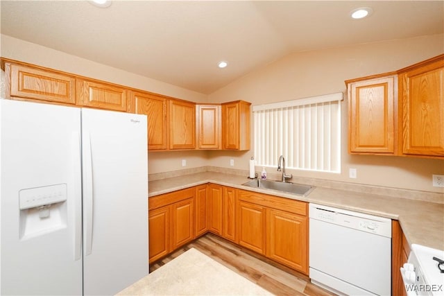 kitchen with light countertops, lofted ceiling, recessed lighting, white appliances, and a sink