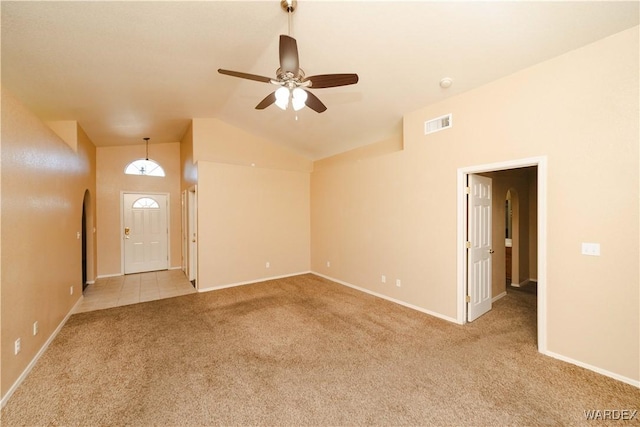 unfurnished living room featuring visible vents, baseboards, ceiling fan, vaulted ceiling, and carpet floors