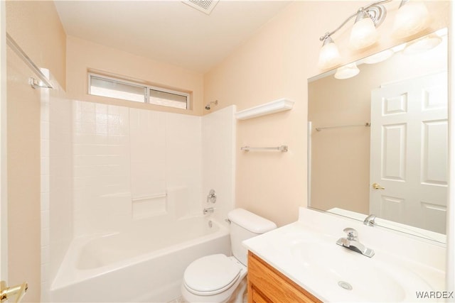 bathroom with visible vents, vanity, toilet, and  shower combination