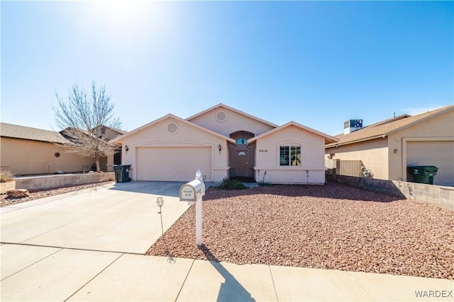 single story home with stucco siding, driveway, and an attached garage