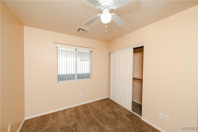 unfurnished bedroom featuring a closet, visible vents, baseboards, and carpet