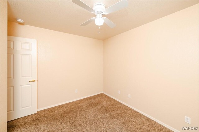 unfurnished room with a ceiling fan, baseboards, and carpet floors