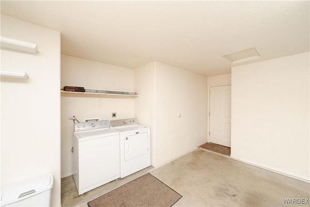 laundry room featuring laundry area, attic access, and washing machine and clothes dryer