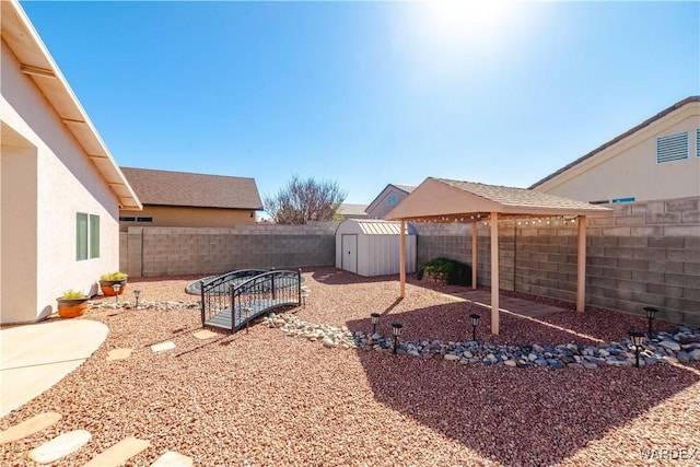 view of yard featuring a storage unit, an outbuilding, and a fenced backyard