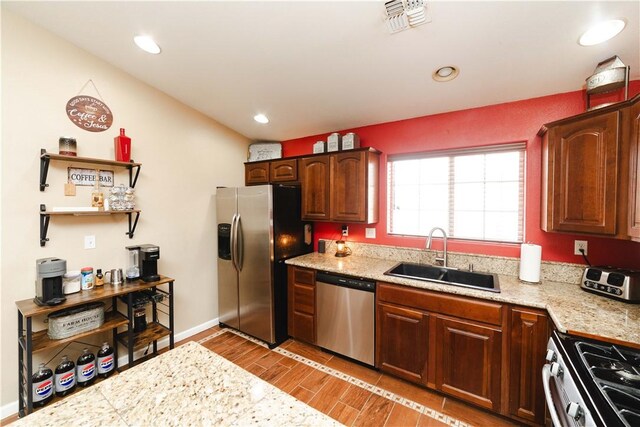3048 Mallory Loop, Kingman, AZ 86401 - kitchen featuring appliances with stainless steel finishes, a sink, light countertops, light wood finished floors, and recessed lighting