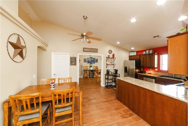 3048 Mallory Loop, Kingman, AZ 86401 - kitchen with stainless steel appliances, lofted ceiling, ceiling fan, light stone counters, and recessed lighting